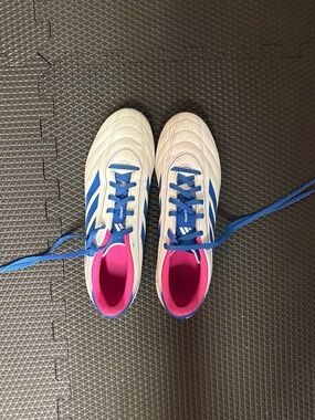 adidas Kids White cleats with Blue Stripes and Pink Lining